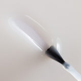 Seche Matte Flat Finish Top Coat brushed onto white background with a downward stroke