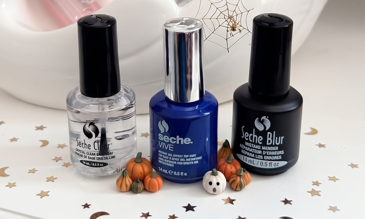 Seche Clear, Seche Vive, and Seche Blur nail products surrounded by mini pumpkins, a ghost, and gold stars and moons.